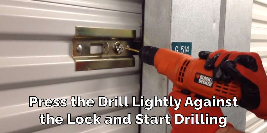Press the Drill Lightly Against
the Lock and Start Drilling