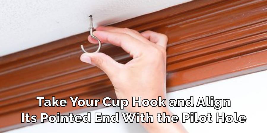 Take Your Cup Hook and Align
Its Pointed End With the Pilot Hole